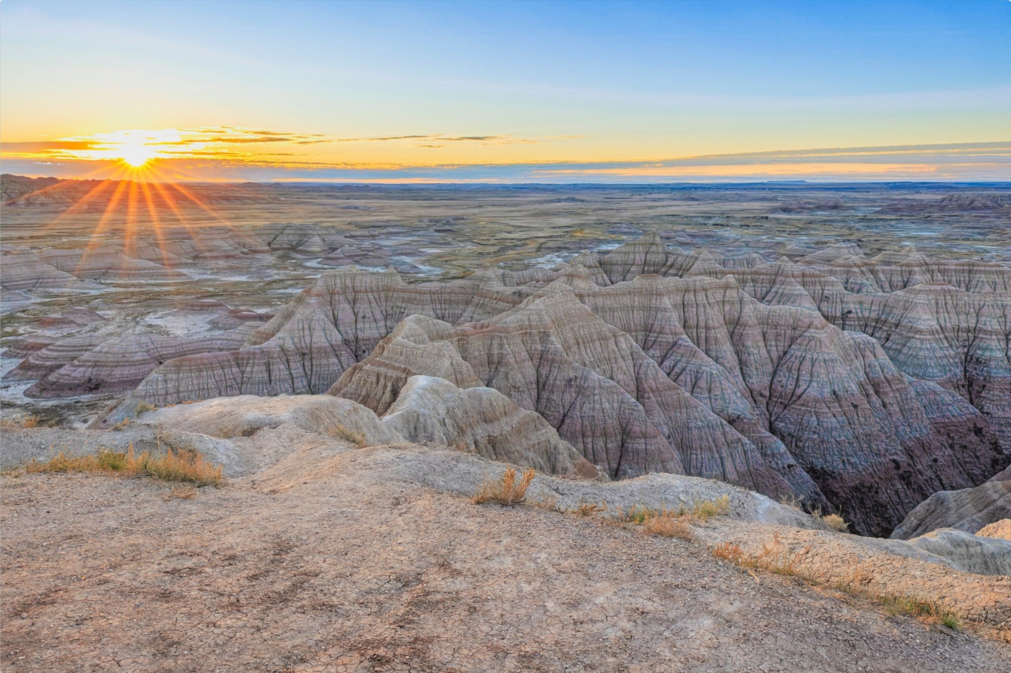 Sunrise over a desert landscape with rocky formations